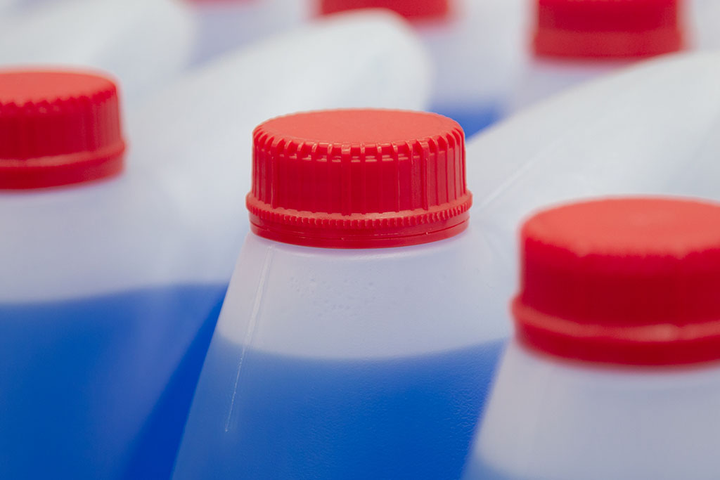 Blue Windshield washer fluid, Professional Refill Blue color, chemicals in plastic bottles cans in the warehouse store. Antibacterial Liquid Wash in plastic canisters with red plastic cork cap.